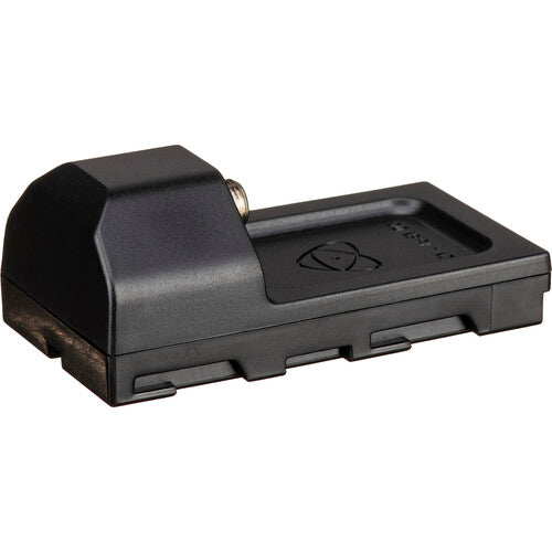 Top-front angled view of the black Atomos AtomX Battery Eliminator NP-F style dummy battery plate with DC barrel connector, Atomos CAST logo, and voltage rating label