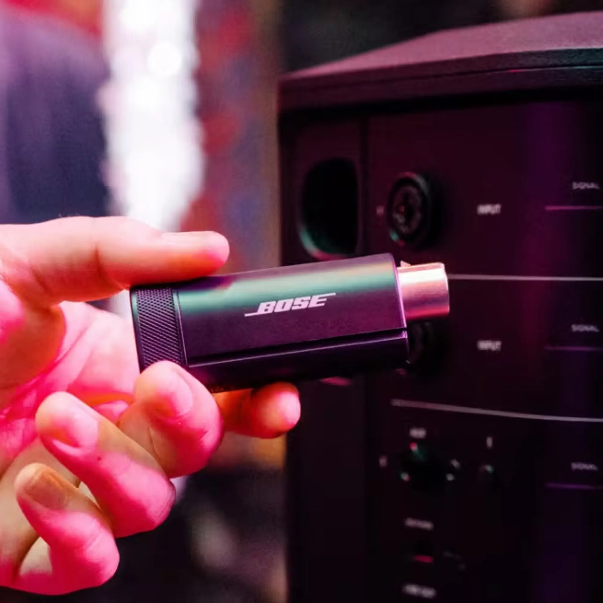 Lifestyle image of Bose S1 Pro+ Wireless Mic/Line Transmitter with an XLR connection, predominantly black in color.