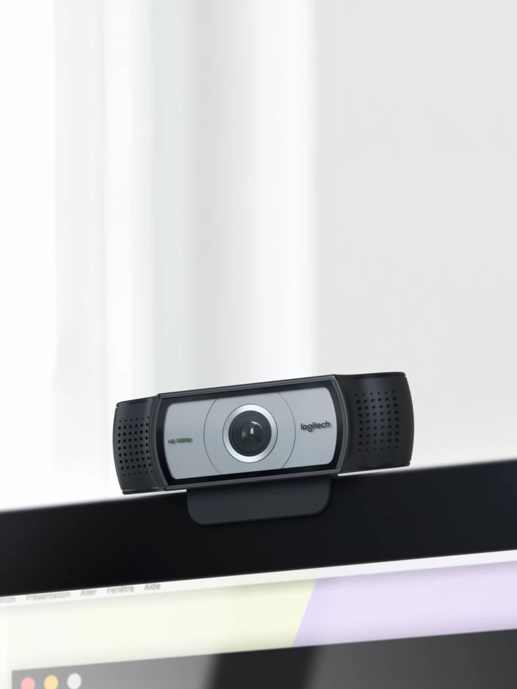 Logitech C930e webcam mounted on laptop screen edge, showing 90-degree view lens and clip