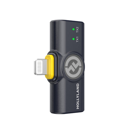 Hollyland Lark M2 shine charcoal Lightning receiver dongle angled view: black USB adapter with Lightning plug (yellow accent), Hollyland logo, green TX1 and TX2 status LEDs on, coiled cable, dual-channel wireless lavalier receiver for iOS