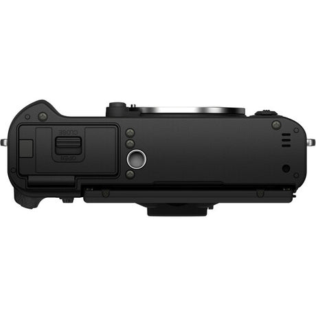 Bottom view of the black Fujifilm X-T30 II mirrorless camera body showing the vintage-style textured grip, X-mount lens port, and top-plate control dials