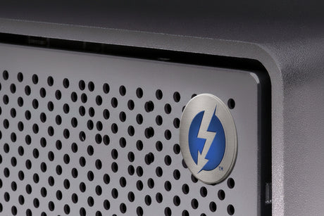 Close-up of G-Technology G-RAID 2 Thunderbolt 3 External Hard Drive with an all-aluminum enclosure and a logo on a dark background.