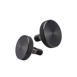 Two black knurled knobs on a white background