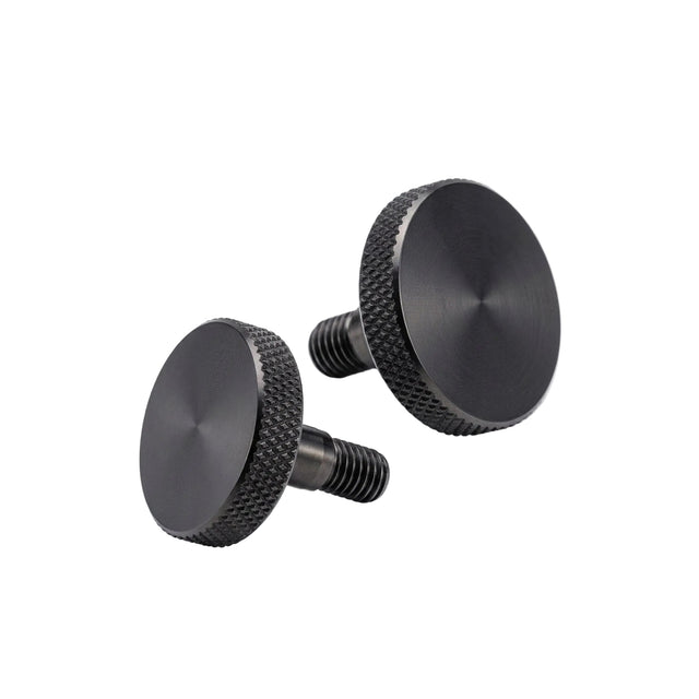 Two black knurled knobs on a white background
