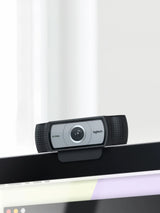Logitech C930e webcam mounted on laptop screen edge, showing 90-degree view lens and clip