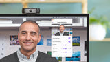 Logitech C930e webcam mounted on monitor displaying man in video call preview with image settings panel open