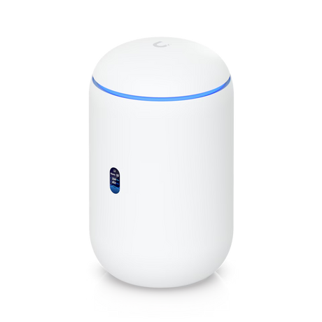 A compact, cylindrical white Ubiquiti UniFi Dream Router (UDR) WiFi 6 gateway standing upright on a neutral background, featuring a glossy polycarbonate finish, subtle ventilation on the sides, a blue status LED ring around the dome-shaped top antenna area, and rear Gigabit Ethernet ports including PoE LAN connections for network devices