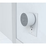 Ubiquiti UniFi Protect WiFi Chime plugged into wall outlet beside UniFi doorbell setup, illustrating real‑world placement and wireless notification integration