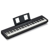 Angled view of a Yamaha P-45B black 88-key digital piano with an attached sheet music rest, showing the full-sized weighted keyboard and slim, portable body design