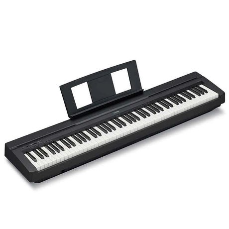 Angled view of a Yamaha P-45B black 88-key digital piano with an attached sheet music rest, showing the full-sized weighted keyboard and slim, portable body design